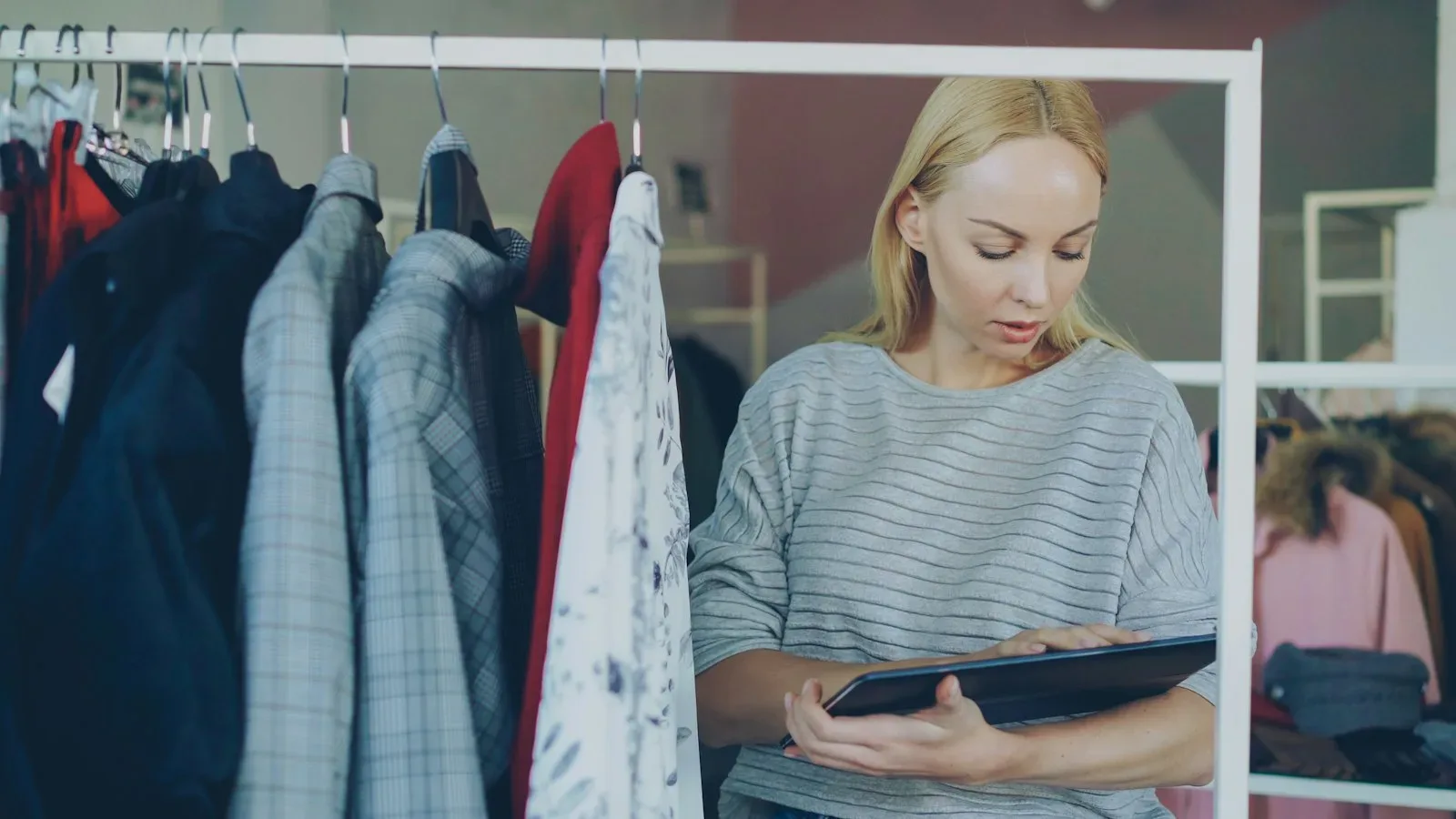 Retail back‑room showing lean JIT inventory setup with tablet and organized shelves