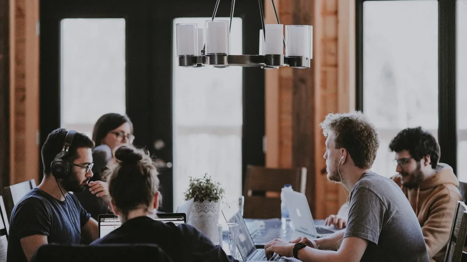 Small‑business team members working remotely together on laptops and video calls