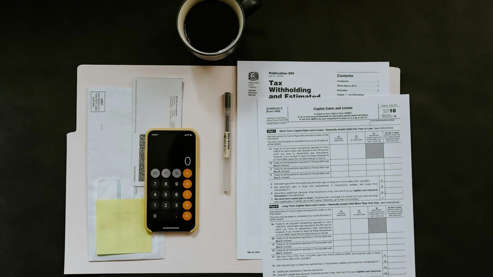 Small business owner reviewing overdue invoices on desk