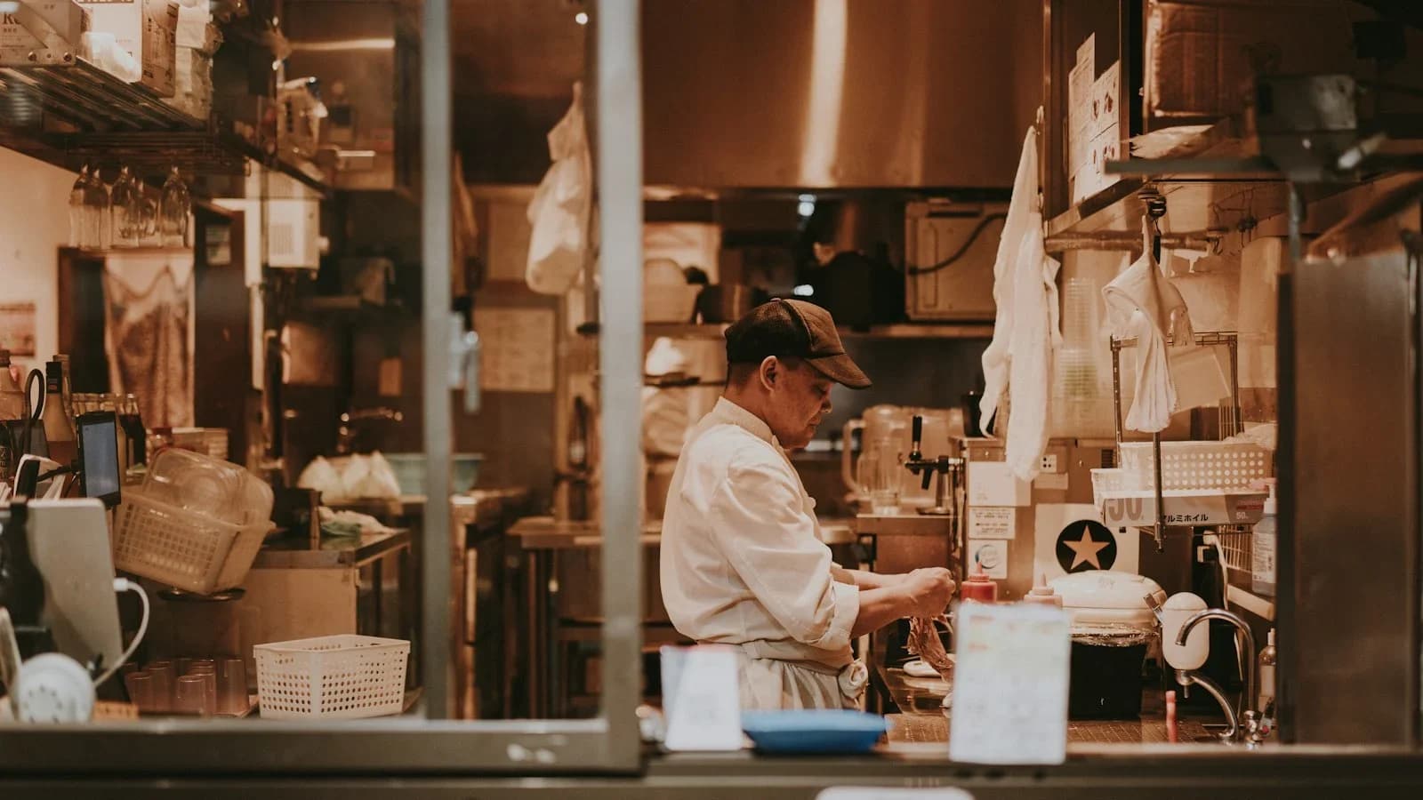 Restaurant owner analyzing food‑cost spreadsheet in a kitchen