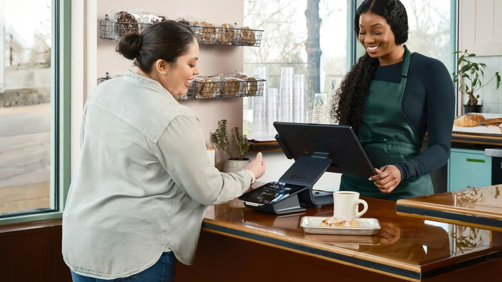 Small business owner discussing a refund with a customer at a checkout counter