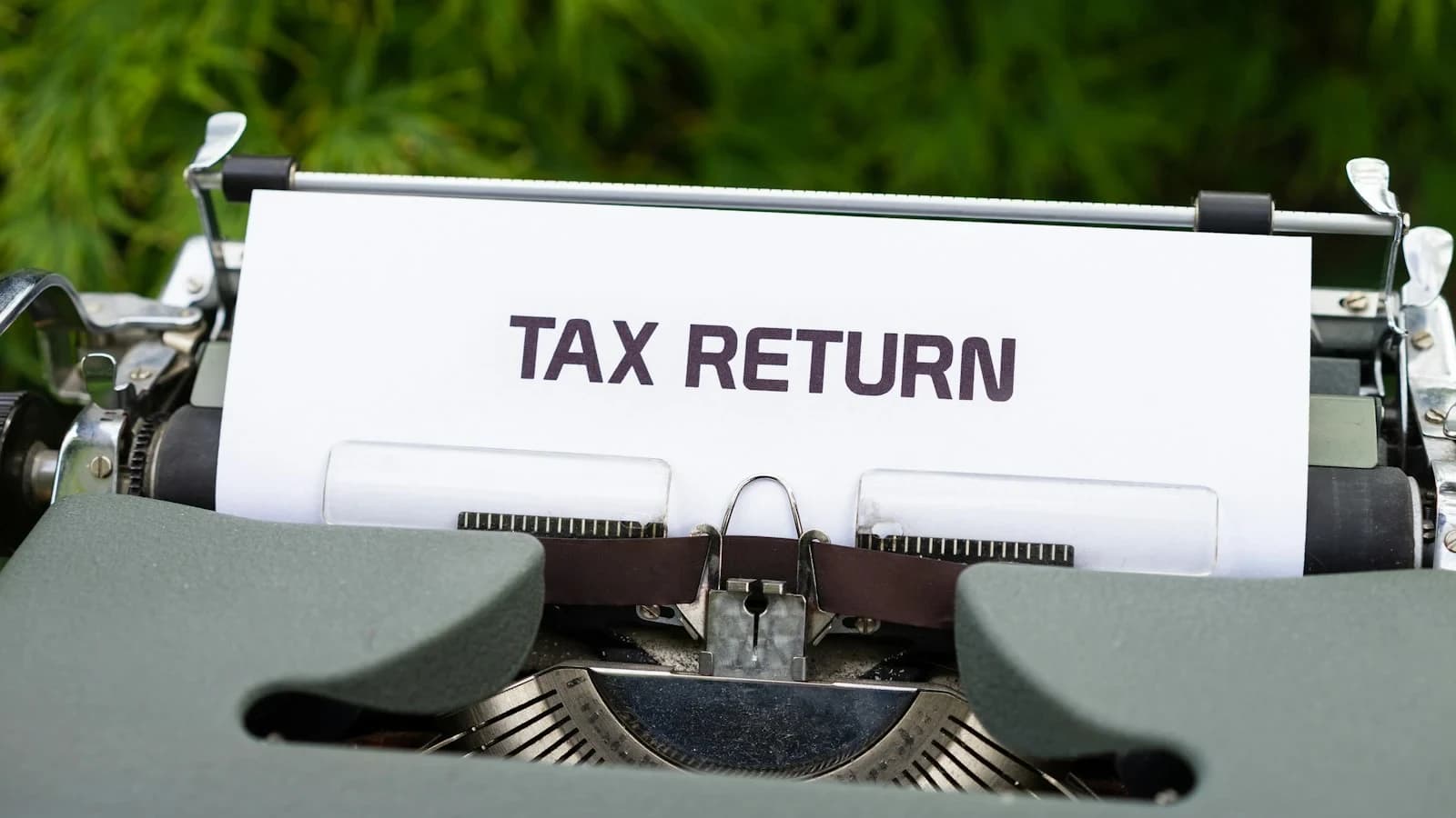 Small business owner reviewing payroll tax deposits on a laptop
