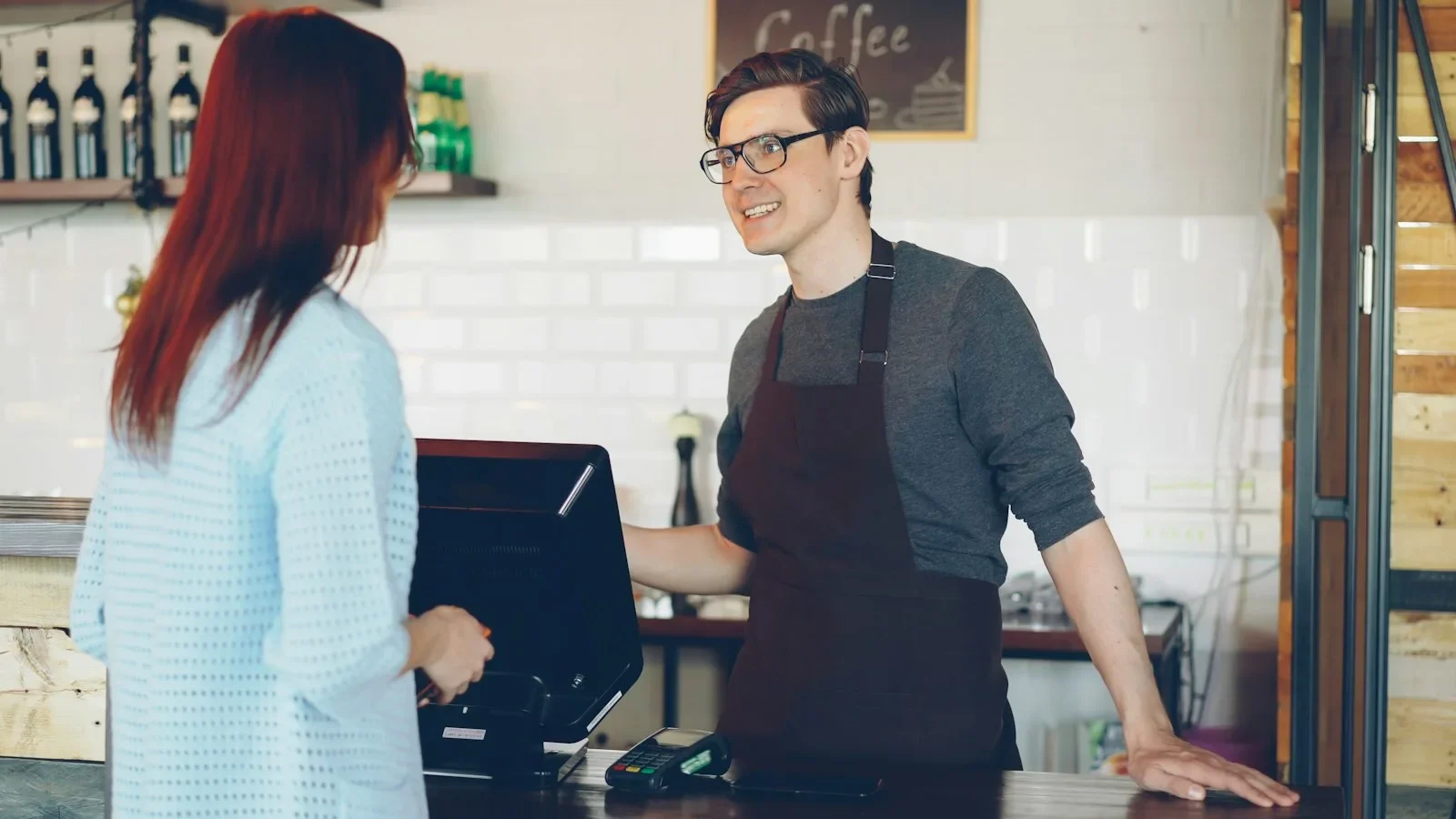 Busy small‑business owner reviewing a concise refund policy on a laptop