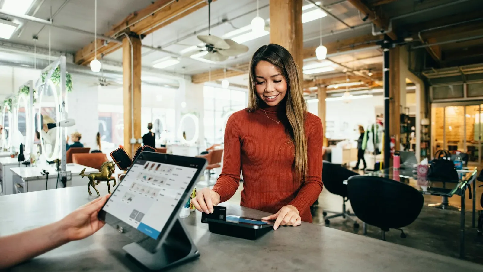 Small business owner reviewing invoices and cash‑flow data at a desk