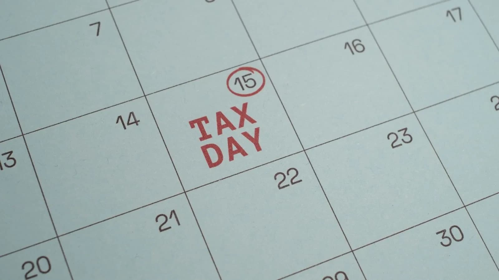 Busy owner managing payroll tax deposits on a laptop