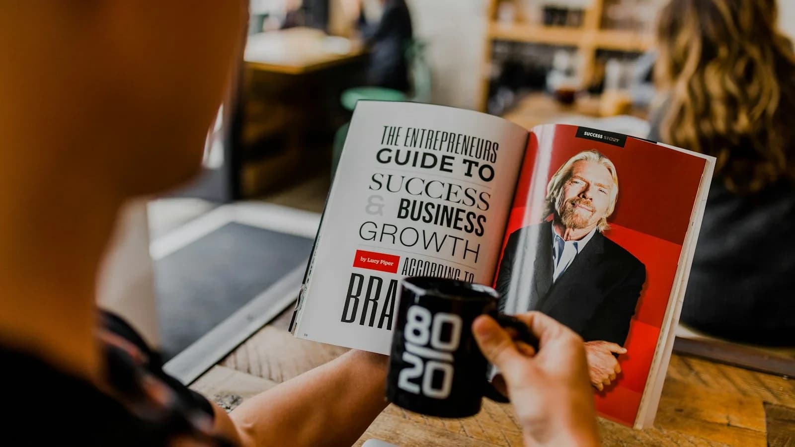 Small business owner reviewing a digital employee handbook at a desk