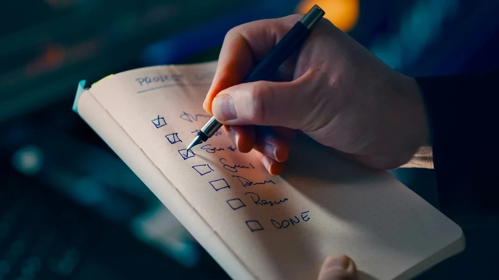 Small business owner reviewing a bookkeeping checklist with a professional bookkeeper at a desk