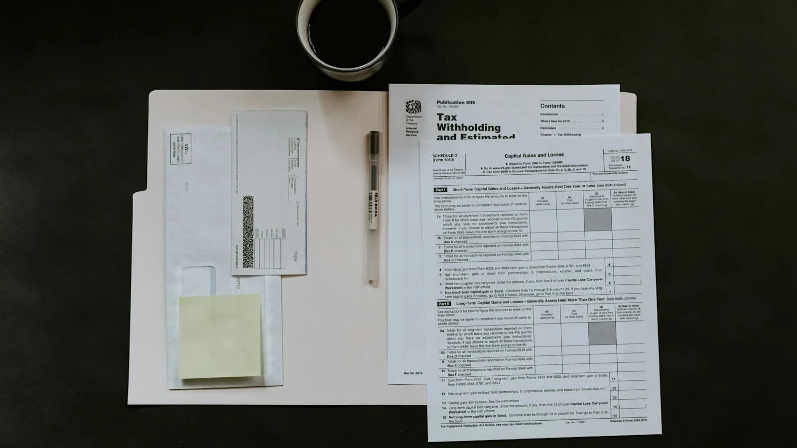 Small business owner reviewing overdue invoices on desk