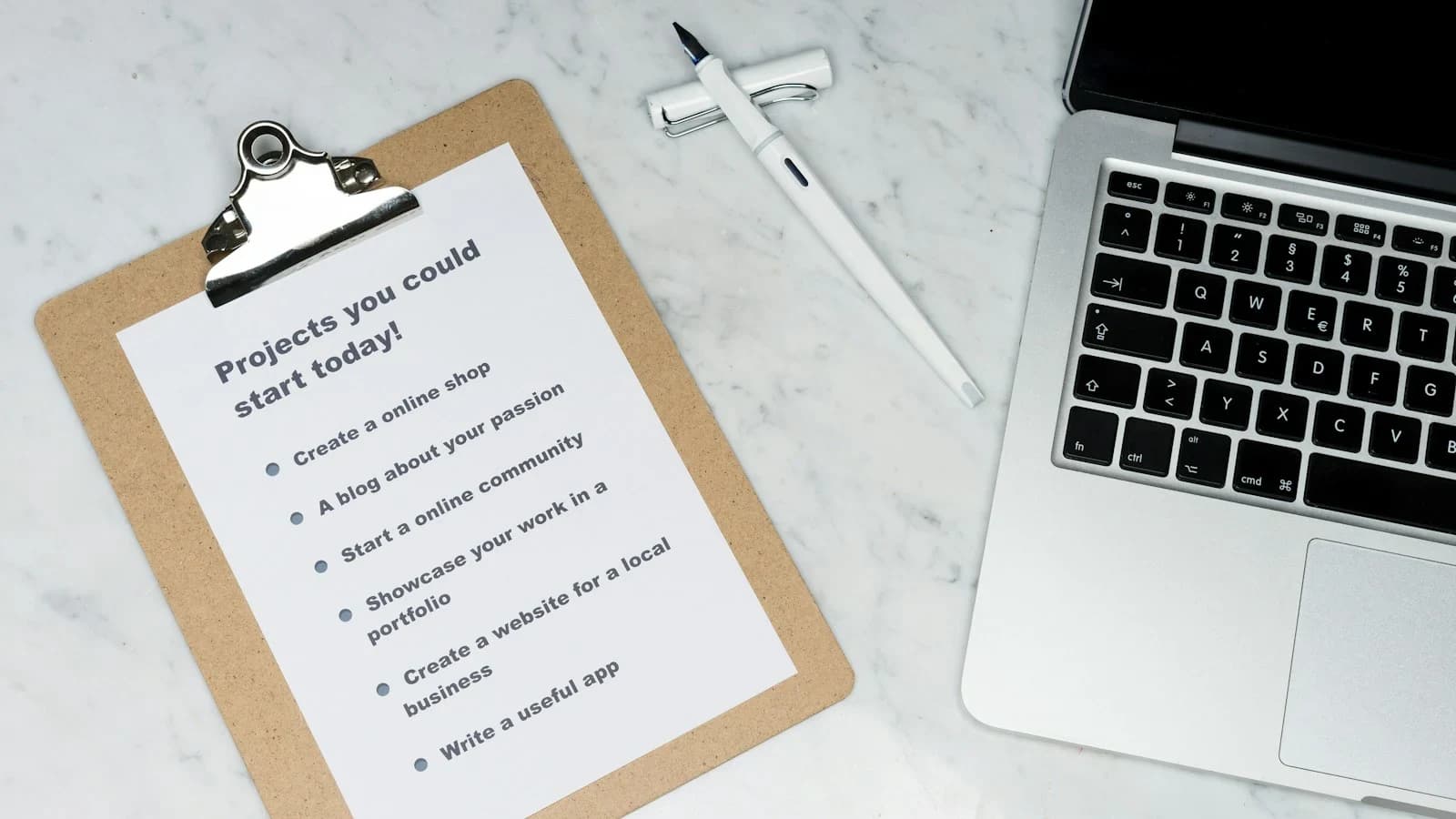 Small business owner reviewing a negative online comment on a laptop, with a checklist nearby
