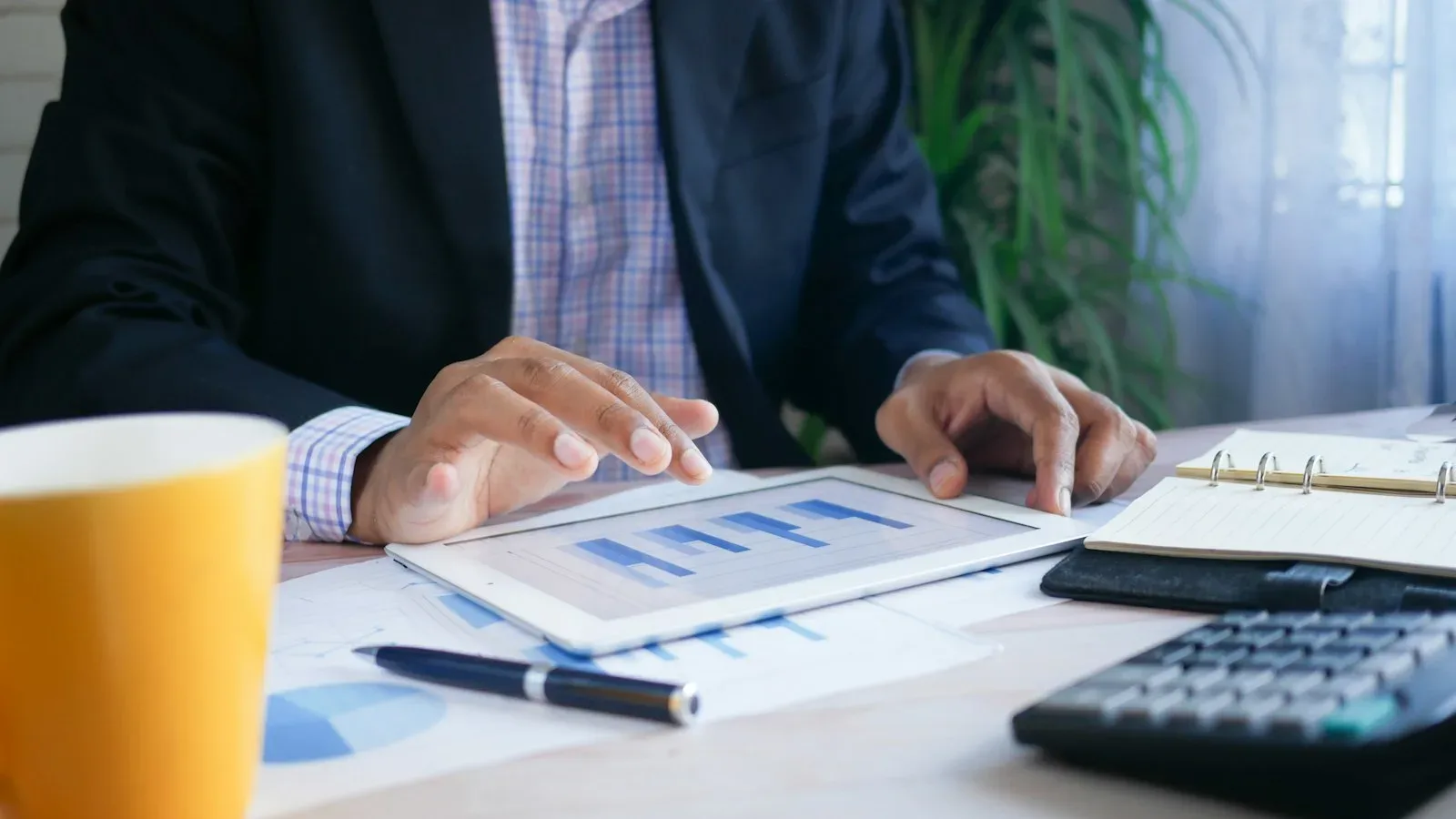Small business owner analyzing inventory forecast dashboard on laptop